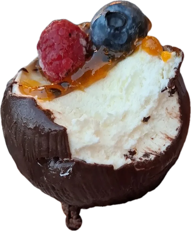 Chocolate shell filled with cream, raspberry and blueberry