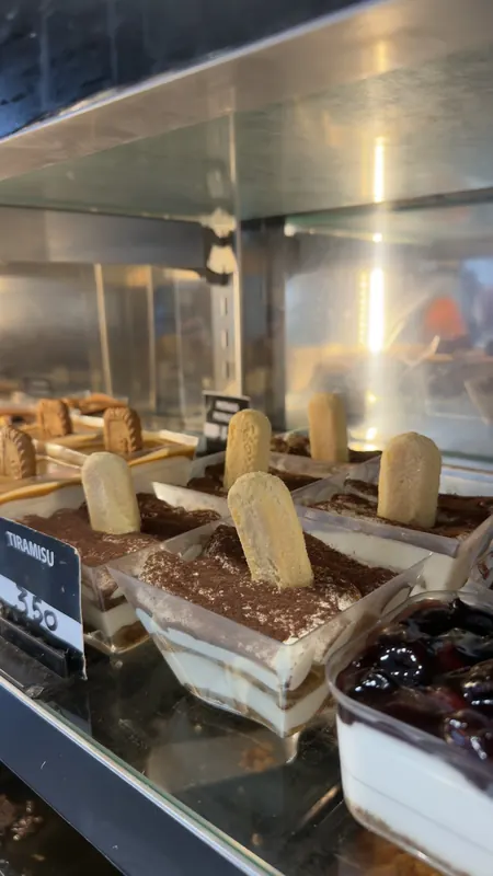 Tiramisu cups with ladyfingers and cocoa in the display